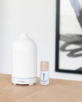 Minimalist stone scent diffuser next to Norwegian Spruce diffuser oil