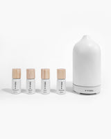Helse Citrus Kit diffuser oils next to white stone scent diffuser