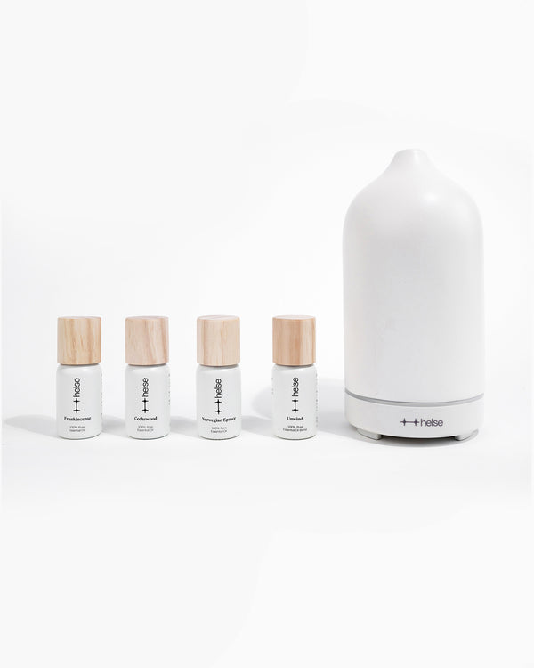 Grounding Kit diffuser oils next to Helse white stone scent diffuser