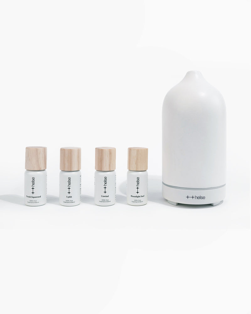 Signature kit of diffuser oils next to white stone scent diffuser
