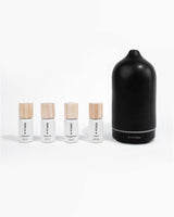 Grounding Kit diffuser oils next to Helse black stone scent diffuser