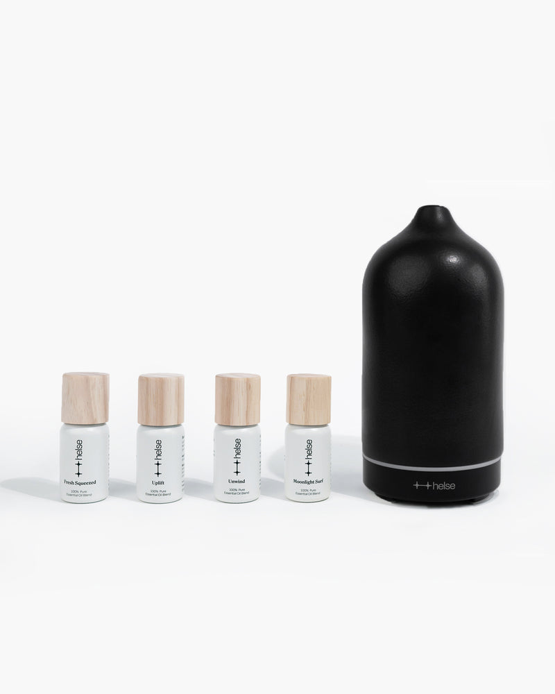 Signature kit of diffuser oils next to black stone scent diffuser